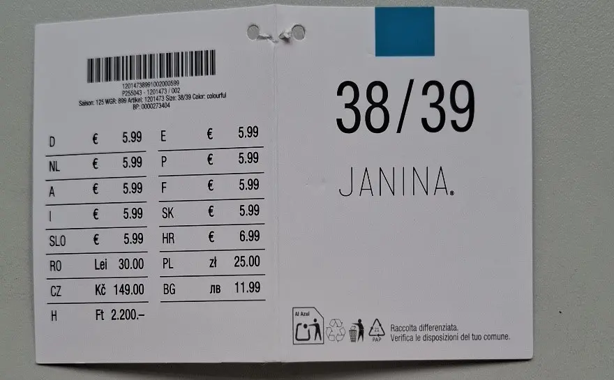Kledinglabel met maat 38/39 voor “JANINA” met prijsinformatie in verschillende valuta's en productcodes.