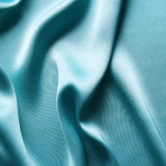 RWS Zertifikat Close-up van een turquoise satijnen stof die glanst in het licht.